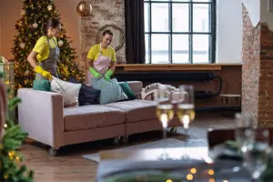 Two professional maids cleaning a residential living room with a Christmas tree just in time for the holidays in Springfield, IL.