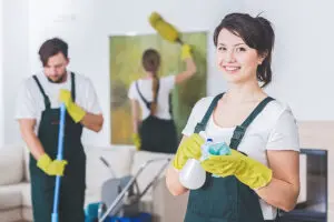 A team of three residential cleaning maids in Springfield, IL that is sweeping, dusting, and wiping down the surfaces of a home.