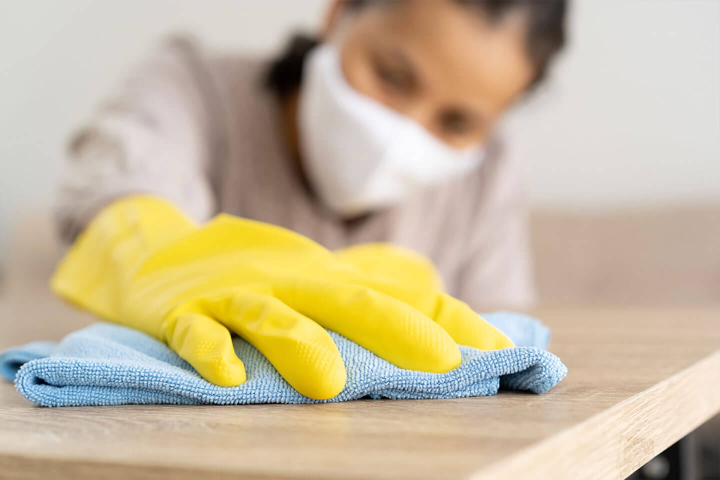 woman with a yellow glove cleaning counter Chatham Illinois