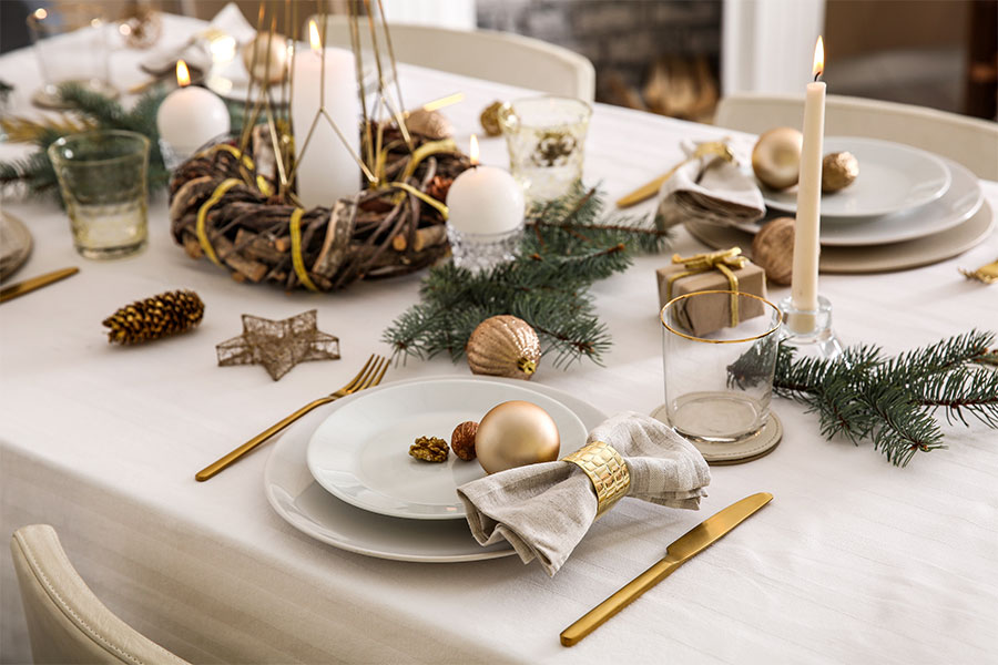 Clean and organized holiday table setting with gold silverware and candle centerpieces by a professional home cleaning crew in Springfield, IL.