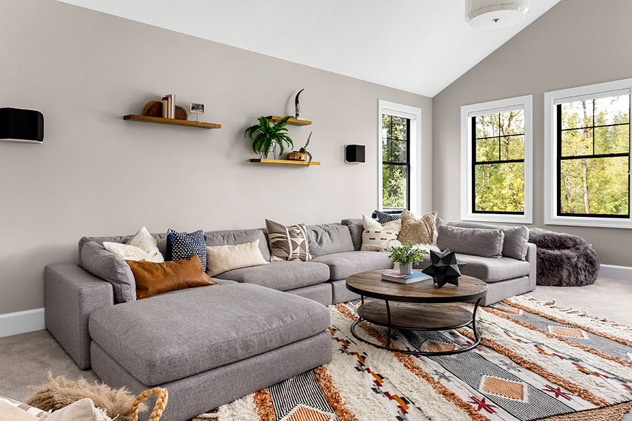 A clean living room with a grey couch and modern décor in Springfield, IL that has been kept tidy with tips from our expert maids.