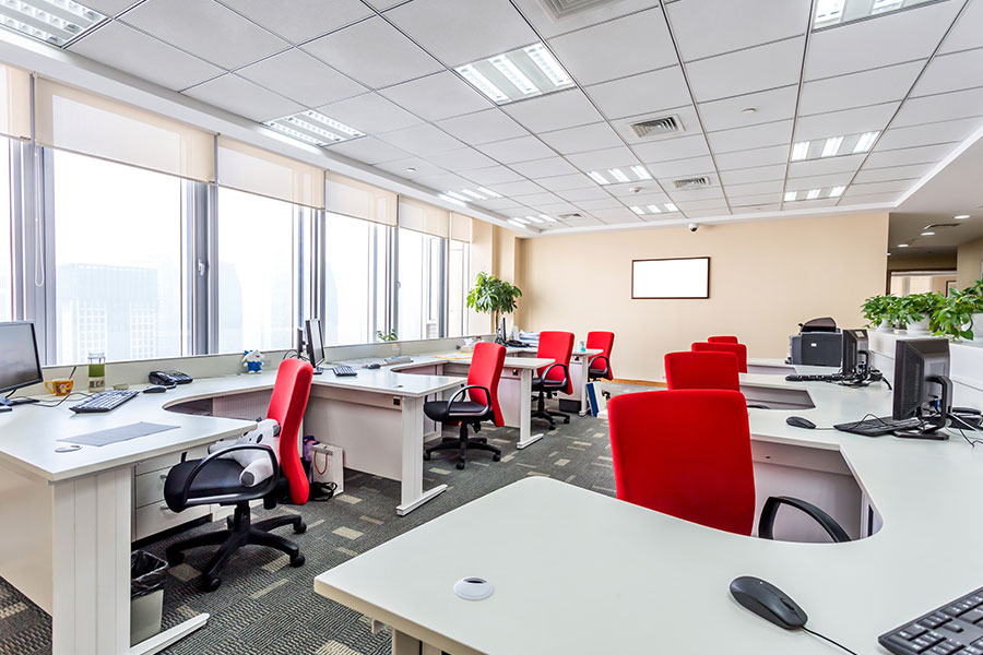 A clean office in Springfield, IL with red chairs and white desks that are spotless thanks to a janitorial cleaning service for your business.