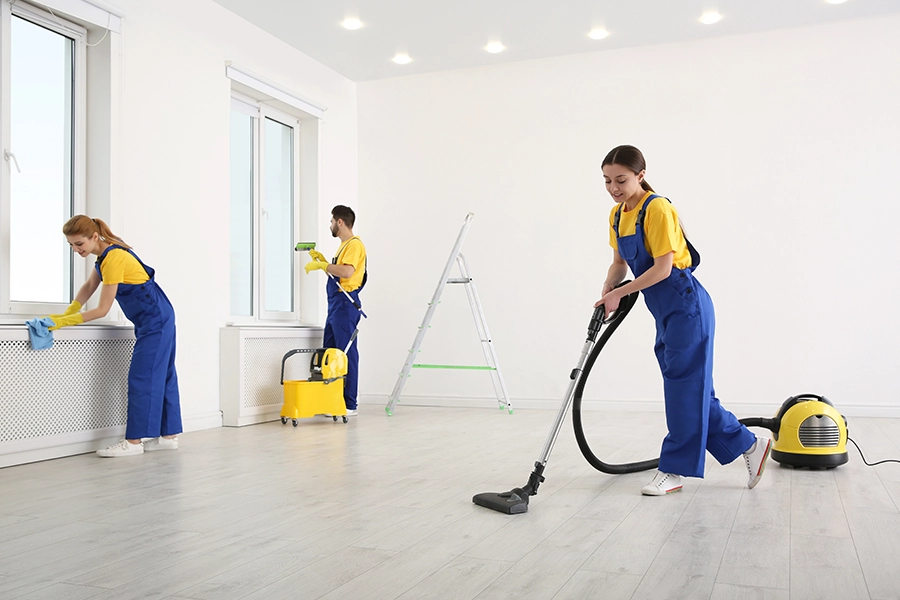 A team of professional cleaners in uniforms thoroughly cleaning a home that’s just been renovated in Lincoln, IL.