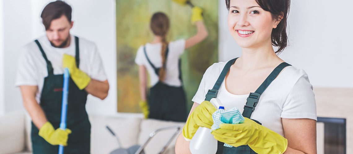 A team of three residential cleaning maids in Springfield, IL that is sweeping, dusting, and wiping down the surfaces of a home.